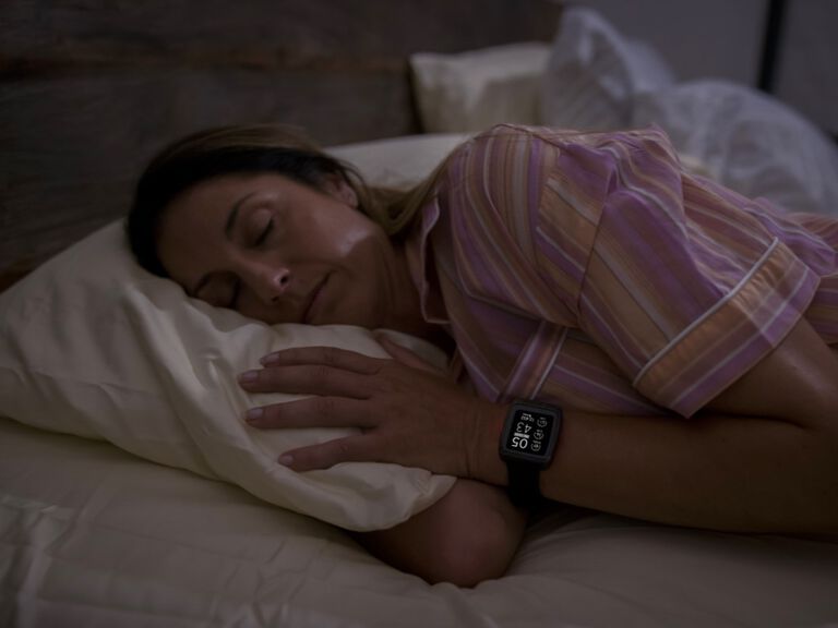 sleeping woman wearing masimo watch
